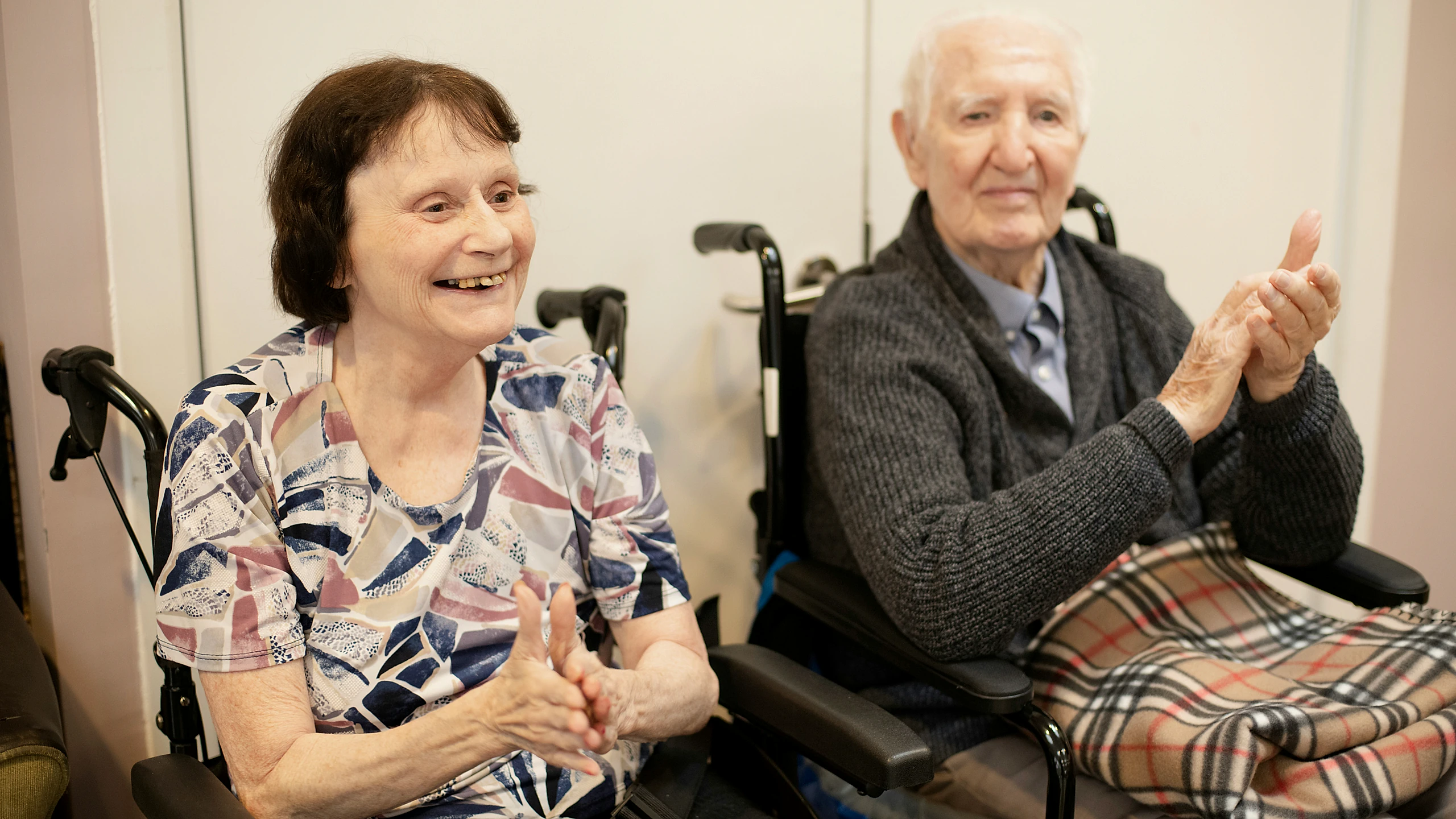 Older adults sitting outside in winter clothing