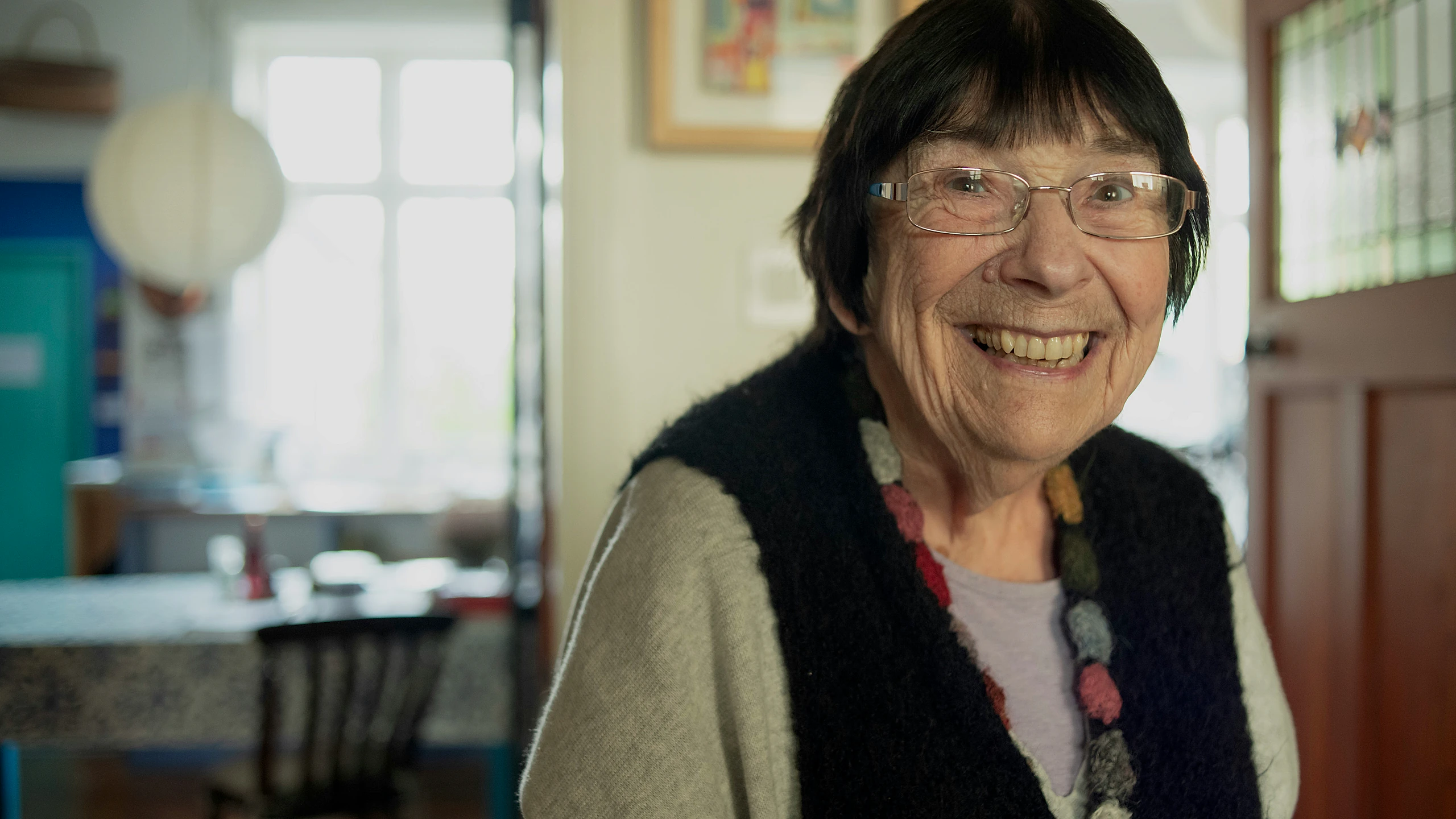 Older woman smiling in a living room